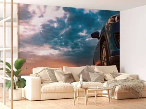 Outlet Een blauwe SUV met een unieke lucht op de achtergrond fotobehang Kinderkamer | Transport