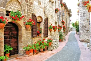 Online Italiaans straatje met veel bloemen fotobehang Architectuur