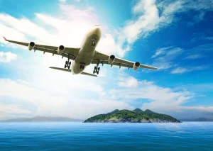 Best Passagiersvliegtuig boven een tropische zee fotobehang Tienerkamer | Transport