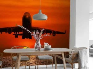 Best Passagiersvliegtuig boven de zee bij zonsondergang fotobehang Transport