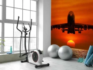 Best Passagiersvliegtuig boven de zee bij zonsondergang fotobehang Transport