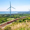 Online Rode trein langs windmolens fotobehang Transport