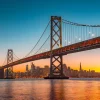 Online San Francisco-Oakland Bay Bridge in de avond fotobehang Architectuur