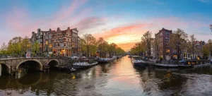 Outlet Zonsondergang in Amsterdam fotobehang Steden | Architectuur